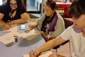 Participants enjoying creating their own manga characters